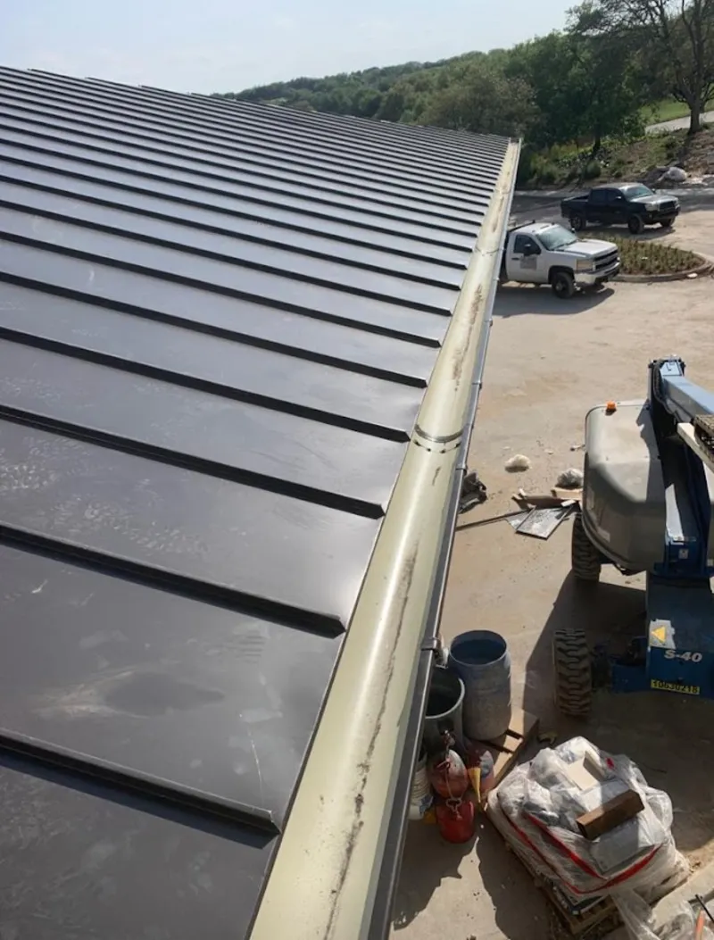 Standing seam panel and gutter detail on a metal roofing jobsite in Henderson
